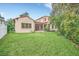 Expansive backyard offering a grassy lawn and home view at 1233 Aquila Loop, Celebration, FL 34747