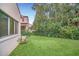 Large backyard with grassy area and mature trees at 1233 Aquila Loop, Celebration, FL 34747
