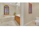 Elegant bathroom with soaking tub, double vanity, and separate toilet area at 1233 Aquila Loop, Celebration, FL 34747