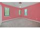 Bedroom with pink walls, gray carpet, and two windows with blinds at 1233 Aquila Loop, Celebration, FL 34747