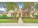 Front view of charming house with walkway and neatly landscaped yard at 1233 Aquila Loop, Celebration, FL 34747