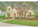 Spanish style home with well manicured lawn and mature trees at 1233 Aquila Loop, Celebration, FL 34747