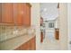 Additional kitchen area with wood cabinets and granite countertops at 1233 Aquila Loop, Celebration, FL 34747