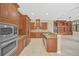 Well-equipped kitchen with wood cabinets and granite counters at 1233 Aquila Loop, Celebration, FL 34747