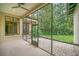 Spacious screened porch with a view of the backyard and surrounding trees at 1233 Aquila Loop, Celebration, FL 34747