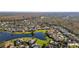 Aerial view of a beautiful community with houses surrounding a lake at 1287 Glendora Rd, Kissimmee, FL 34759