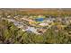 Aerial view showcasing a house with pool in a tree-lined community at 1287 Glendora Rd, Kissimmee, FL 34759