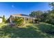 Spacious backyard with a large covered patio and solar panels at 1287 Glendora Rd, Kissimmee, FL 34759