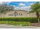Solvita community entrance with lush landscaping and signage at 1287 Glendora Rd, Kissimmee, FL 34759