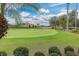 Putting green with palm trees and beautiful landscaping at 1287 Glendora Rd, Kissimmee, FL 34759