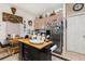 Kitchen with stainless steel refrigerator and island with butcher block top at 1287 Glendora Rd, Kissimmee, FL 34759