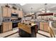 Kitchen features light wood cabinets and stainless steel appliances at 1287 Glendora Rd, Kissimmee, FL 34759
