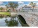 Picturesque stone bridge over a calm reflecting lake at 1287 Glendora Rd, Kissimmee, FL 34759