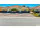Front view of villa with landscaping and paved driveway at 1819 Coriander Dr, Kissimmee, FL 34759