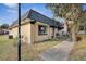 Tan colored single story home with dark roof and walkway at 2203 Silver Pines Pl # 601, Orlando, FL 32808