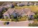 Aerial view of apartment buildings, with ample parking and surrounding landscape at 2302 Butterfly Palm Way # 303, Kissimmee, FL 34747