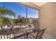 Screened balcony with seating for two and a view of the community at 2302 Butterfly Palm Way # 303, Kissimmee, FL 34747