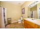Clean bathroom with shower/tub combo, wood vanity, and neutral color scheme at 2302 Butterfly Palm Way # 303, Kissimmee, FL 34747