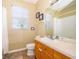 Simple bathroom with shower/tub combo and wood vanity at 2302 Butterfly Palm Way # 303, Kissimmee, FL 34747