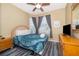 Queen-size bed, wood furniture, and a ceiling fan in a bright bedroom at 2302 Butterfly Palm Way # 303, Kissimmee, FL 34747