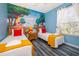 Twin beds, whimsical wall mural, and ample natural light at 2302 Butterfly Palm Way # 303, Kissimmee, FL 34747