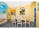 Bright dining area with beach mural and a table for six at 2302 Butterfly Palm Way # 303, Kissimmee, FL 34747