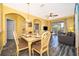 Charming dining area with a table and chairs, adjacent to the living room and kitchen at 2302 Butterfly Palm Way # 303, Kissimmee, FL 34747