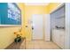 Bright entryway with washer and dryer, tile floors, and access to the main living area at 2302 Butterfly Palm Way # 303, Kissimmee, FL 34747