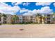 Tan colored apartment building with palm trees and parking at 2302 Butterfly Palm Way # 303, Kissimmee, FL 34747