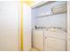 White washer and dryer set in a well-lit laundry closet at 2302 Butterfly Palm Way # 303, Kissimmee, FL 34747