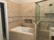 Primary bathroom with soaking tub, walk-in shower, and double vanity at 2303 Walnut Canyon Dr, Kissimmee, FL 34758