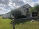 Side view showcasing the house's architectural style and landscaping at 2303 Walnut Canyon Dr, Kissimmee, FL 34758