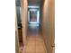 Bright hallway with tile flooring leading to bedrooms and bathroom at 2303 Walnut Canyon Dr, Kissimmee, FL 34758