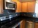 Kitchen area with stainless steel appliances and dark-colored countertops at 2303 Walnut Canyon Dr, Kissimmee, FL 34758