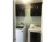 Laundry room with washer and dryer, and dark wood cabinets at 2303 Walnut Canyon Dr, Kissimmee, FL 34758