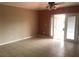 Spacious living room with tile flooring and access to a patio at 2303 Walnut Canyon Dr, Kissimmee, FL 34758