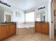 Relax in this double-sink bathroom, featuring a large corner soaking tub at 2603 Isla Bonita Ct, Kissimmee, FL 34747