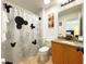 Bathroom with shower/tub combo, granite countertop, and Mickey Mouse shower curtain at 2603 Isla Bonita Ct, Kissimmee, FL 34747