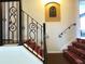 Elegant staircase with wrought iron railing and carpet runner at 2603 Isla Bonita Ct, Kissimmee, FL 34747