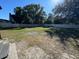 Large backyard with grassy area, partially fenced, and a shed at 2614 Pineway Dr, Orlando, FL 32839