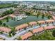 Aerial view showing community pool, lake, and surrounding buildings at 2618 Bugatti Ct, Kissimmee, FL 34746