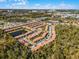 Large townhome community with pond and surrounding trees at 2618 Bugatti Ct, Kissimmee, FL 34746