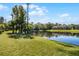 Landscaped backyard with pond view at 2618 Bugatti Ct, Kissimmee, FL 34746