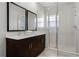 Modern bathroom with a double vanity and walk-in shower at 2618 Bugatti Ct, Kissimmee, FL 34746