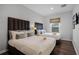 Bright bedroom with two twin beds, a window and wood floors at 2618 Bugatti Ct, Kissimmee, FL 34746