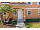Townhouse entry with walkway, landscaping, and front door at 2618 Bugatti Ct, Kissimmee, FL 34746