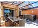 Relaxing screened patio with hot tub and outdoor dining area at 2618 Bugatti Ct, Kissimmee, FL 34746