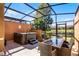 Spacious screened patio with hot tub, table, and seating at 2618 Bugatti Ct, Kissimmee, FL 34746
