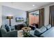 Cozy living room with two sofas, a coffee table, and access to a patio at 2618 Bugatti Ct, Kissimmee, FL 34746