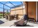 Relaxing screened patio with seating and outdoor dining area at 2618 Bugatti Ct, Kissimmee, FL 34746